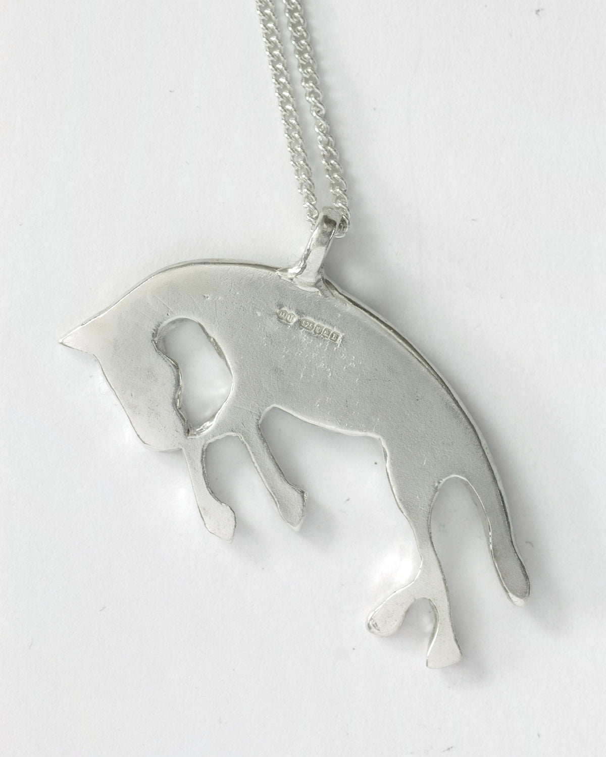 Let's Ride horse pendant necklace in sterling silver by Meg Henry featuring a hand-carved sculptural horse design with a satin finish.