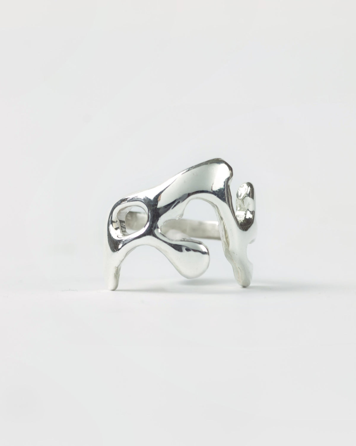Molten ring in sterling silver by Meg Henry featuring a fluid sculptural design inspired by flowing molten metal.