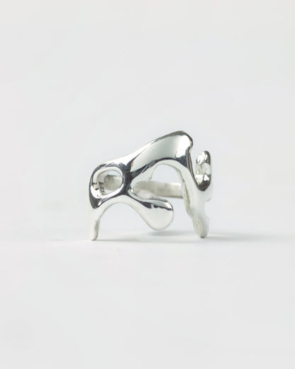 Molten ring in sterling silver by Meg Henry featuring a fluid sculptural design inspired by flowing molten metal.