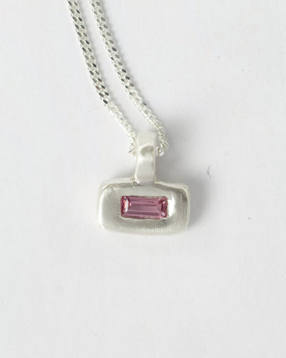 Pink Pillow pendant necklace in sterling silver by Meg Henry featuring a pink lab sapphire in a chunky satin-finished sculptural pendant on a curb chain